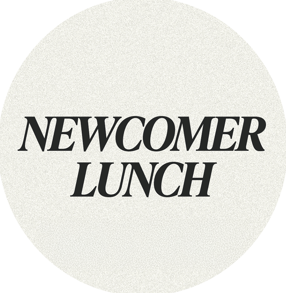A circular badge with a textured beige background featuring the text "NEWCOMER LUNCH" in bold black font at the center.